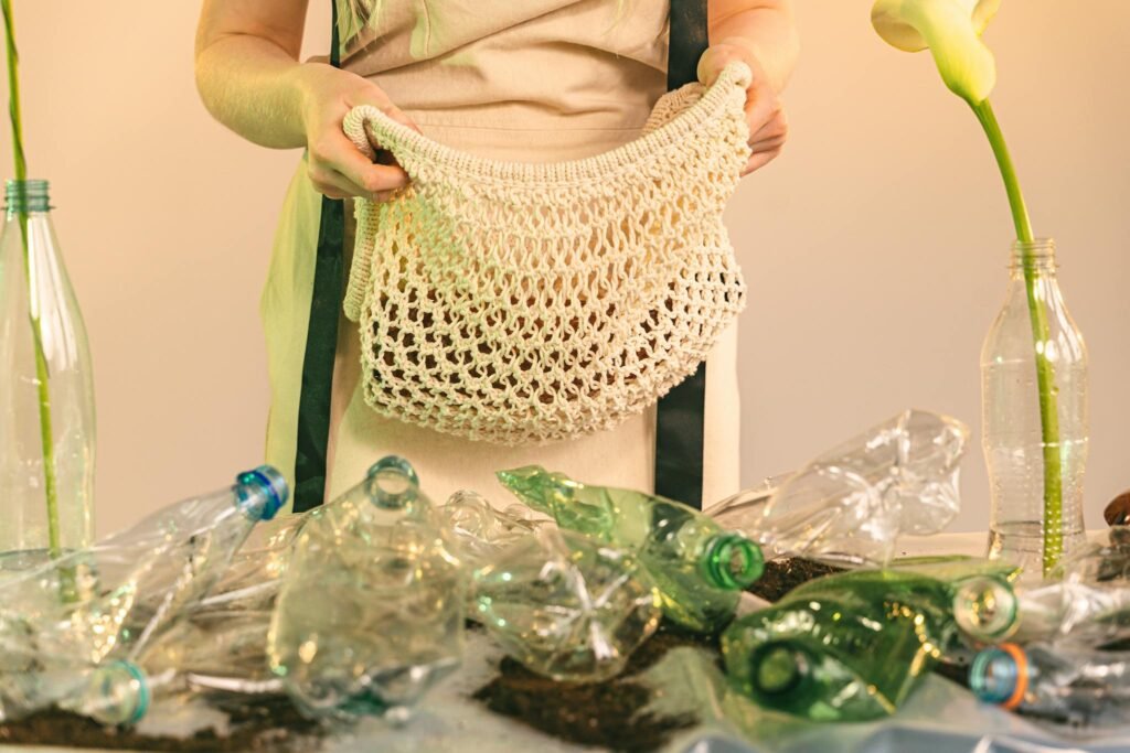 Mesh bag and plastic bottles symbolize recycling and zero waste lifestyle.